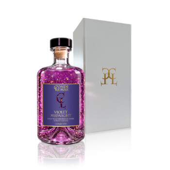 Botella Violet Midnight con láminas de oro 23K junto a su estuche de regalo blanco